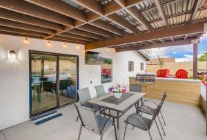 a patio with a table and chairs and a grill at 5BR Oasis - Pool, Hot Tub & Luxe Outdoor Retreat in Santee