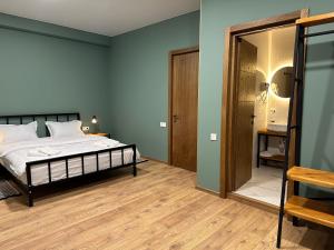 A bed or beds in a room at Hotel Mountime Kazbegi