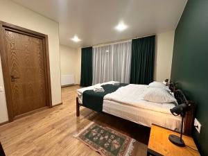 A bed or beds in a room at Hotel Mountime Kazbegi