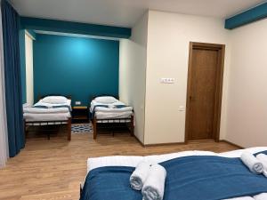A bed or beds in a room at Hotel Mountime Kazbegi