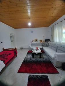 a living room with a couch and a table at Shpija E AMEL (Sweet Guest House) 