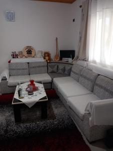 a living room with a couch and a table at Shpija E AMEL (Sweet Guest House) in Ferr-Shkopet
