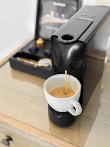 een koffiezetapparaat is het maken van een kopje koffie bij ClubOrsa Ourania's Mansion in Skiathos-stad