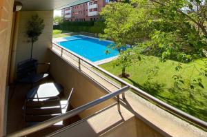 a balcony with a view of a swimming pool at Camino Santiago Naturaleza en Logroño Parking y Piscina by Apartamentos Logrono org in Logroño