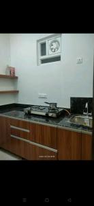 a kitchen counter with a stove and a sink at Executive House in Lucknow
