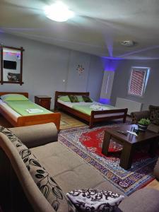 a living room with two beds and a couch at Genex-M in Bugojno