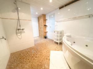 a bathroom with a tub and a shower and a sink at Privatzimmer mit eigenem Eingang und Terasse in Sarstedt