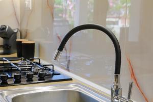 a kitchen sink with a faucet next to a stove at SeaPearl in Paralía Avdhíron +28 photos