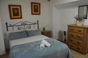 a bedroom with a bed with a towel on it at La Laguna in Almedinilla +13 photos