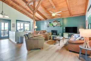 a living room with leather furniture and a ceiling fan at Fox Berry Hill - Lakefront with Dock, Launch & Hot Tub in Waverly +62 photos