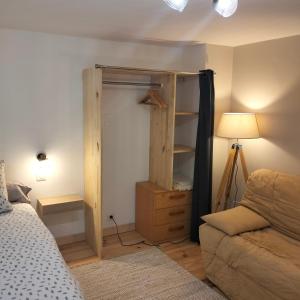 サン・ジュニアンにあるChambres d'hôtes d'Antardieuのベッドルーム1室(クローゼット、ベッド1台、ソファ付)