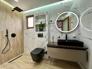 a bathroom with a black sink and a mirror at Vila Laura in Ksamil