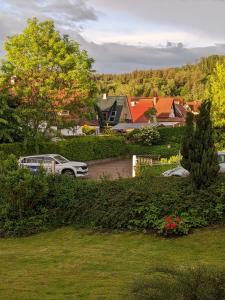 a car parked in a yard next to a house at Gästehaus Regina in Ruhla