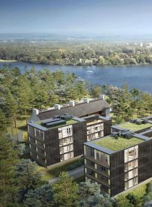 eine Luftansicht von zwei Apartmentgebäuden mit einem Fluss in der Unterkunft My Marina Apartment mit Pool und Sauna am See in Bad Saarow