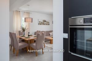a kitchen and dining room with a table and a fireplace at La Mer Adriatique in Makarska