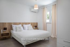 a bedroom with a white bed and a window at La Mer Adriatique in Makarska
