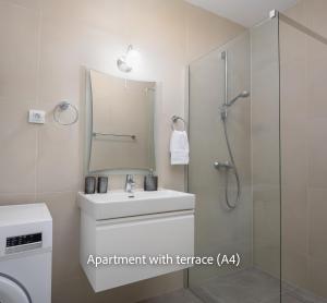 a bathroom with a sink and a shower with a mirror at La Mer Adriatique in Makarska +30 photos