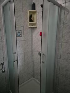 a shower in a bathroom with a door open at Lovely 2-bedroom apartment in Novi Vinodolski in Novi Vinodolski +24 photos