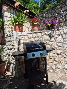 a grill in a stone wall with potted plants at Lovely 2-bedroom apartment in Novi Vinodolski in Novi Vinodolski