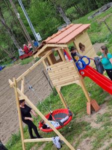 a group of children playing in a play structure at Apartmani kod Kmeta in Janja