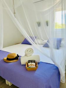 a bedroom with a bed with a canopy at Can Chumbera Formentera in Cala Saona