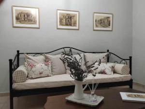 a couch with a vase of flowers on a table at Vintage Garden House in Doxato +32 photos