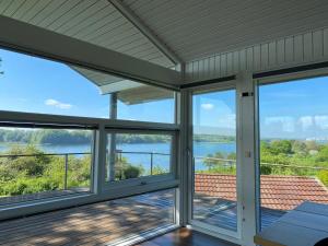 a screened porch with a view of the water at Panorama udsigt in Kolding +10 photos
