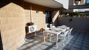 a white table and chairs on a patio at Lecce Holiday Rentals in Lecce