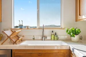 a kitchen with a sink and a window at Lilly's Guesthouse-Farmstay with Valley Views! in Arroyo Grande +42 photos