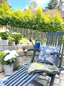 a blue rocking chair with a pillow on a patio at Zauberhaftes Haus in Ortenburg in Ortenburg