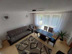 a living room with a couch and a table and chairs at House in Zabierzów in Zabierzów