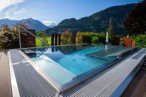 a swimming pool on the roof of a house at SALZANO Hotel - Spa - Restaurant in Interlaken