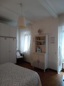 1 dormitorio con 1 cama, armario y silla en Soluna en Maresca