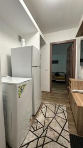 uma cozinha com um frigorífico branco num quarto em Apartament BD 54 em Roman