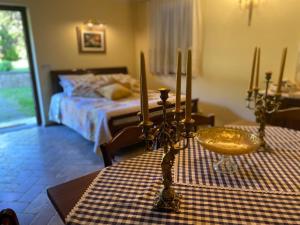 a bedroom with a bed and a table with three candles at Villa Giulia in Gragnola