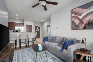 a living room with a couch and a kitchen at HUGE New Apartment, Free Parking, Near Mayo! in Rochester