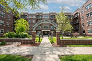 an entrance to a brick building with an arch in front at HUGE New Apartment, Free Parking, Near Mayo! in Rochester