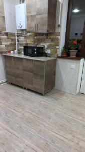 a kitchen with a counter in a room with wooden floors at Mark in Yeghegnadzor
