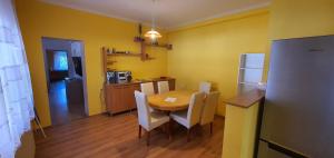 a kitchen with a table and chairs in a room at Szófia Vendégház in Kerekegyháza