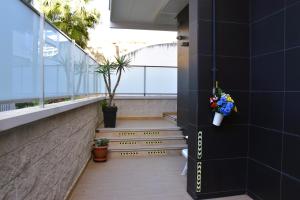 a stairway in a building with plants and flowers at Casa vacanze Fantasia - Nuovo! Accogliente appartamento in Barletta