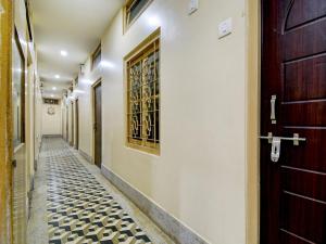 a hallway with a door and a tiled floor at Hotel O Gajraj in Guwahati