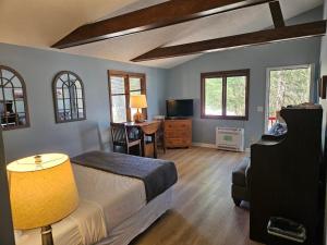 a bedroom with a bed and a table with a chair at Boundary Waters Resort & Marina in Hiawassee