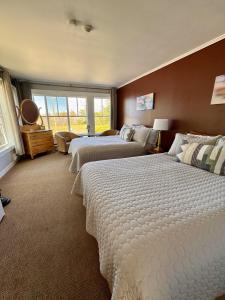 a large bedroom with two beds and a window at Harbourview Inn in Smiths Cove