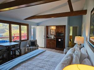 a bedroom with a bed and a table and chairs at Boundary Waters Resort & Marina in Hiawassee