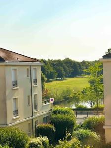 a view of a building with a field in the background at Le VanGogh - grand studio Disney 8 minutes in Bussy-Saint-Georges