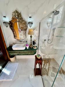 La salle de bains est pourvue d'un lavabo et d'une douche. dans l'établissement Segredo da Serra Guest House, à Tiradentes