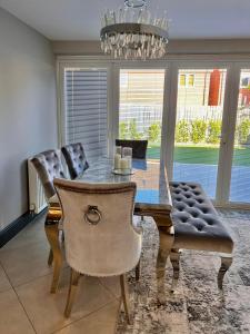a dining room table with chairs and a chandelier at Luxury Durham Home in DH1, Free Parking, No Fees in Durham