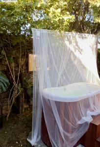 een wit bad met een net eromheen bij Segredo da Serra Guest House in Tiradentes