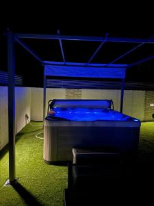 Un dormitorio con una cama con luces azules. en Apartment ANAI, Private heated pool and jacuzzi, en Sukošan