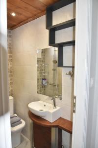 a bathroom with a sink and a toilet at F K Apartments in Artemida +35 photos